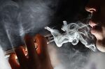 A man vapes an E-Cigarette.