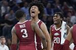 Arkansas forward Trey Wade (3) celebrates with forward Jaylin Williams, middle, and forward Kamani Johnson (20) during the second half of a college basketball game against Gonzaga in the Sweet 16 round of the NCAA tournament in San Francisco, Thursday, March 24, 2022. (AP Photo/Marcio Jose Sanchez)