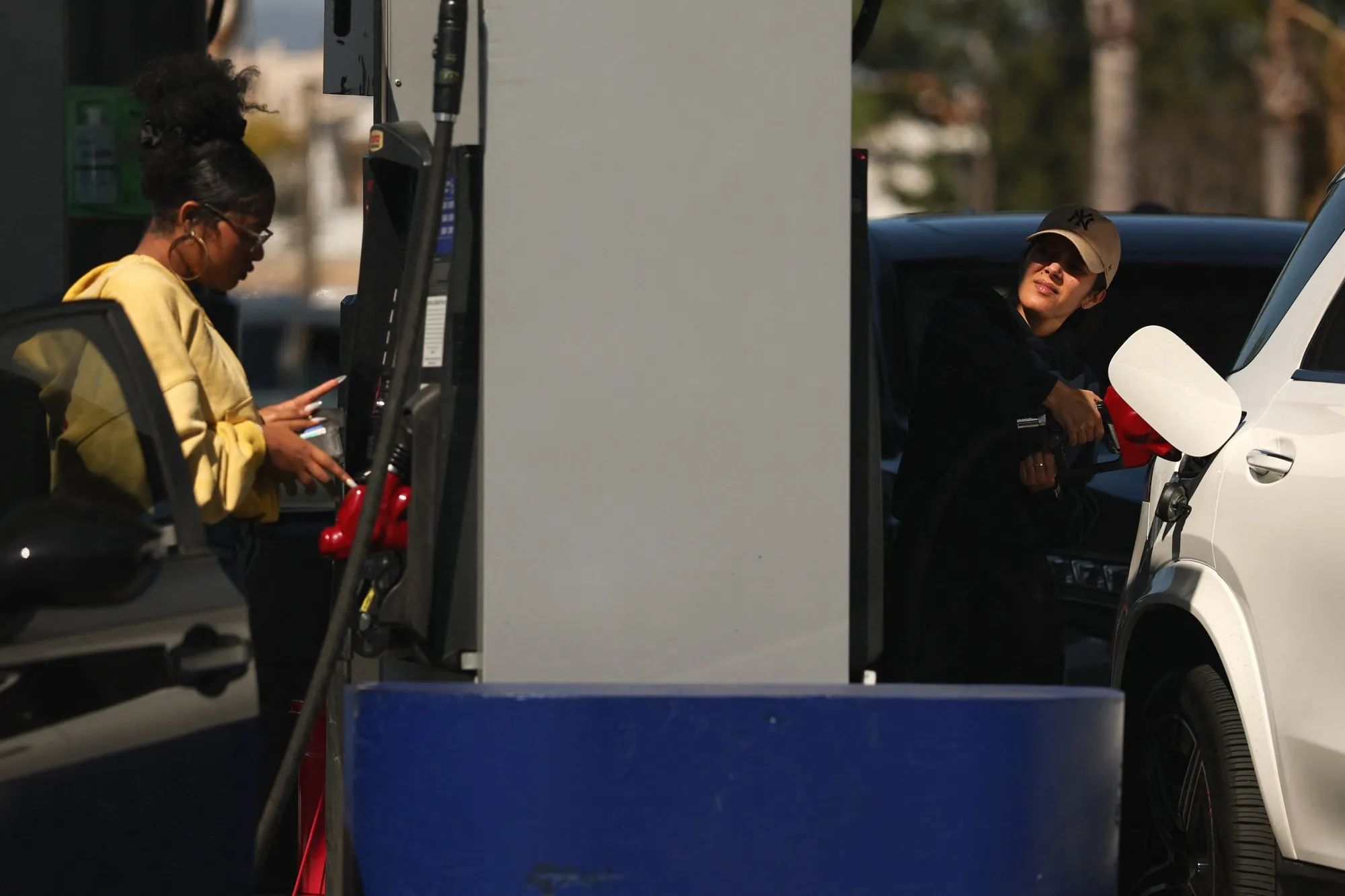 People refuel at a gas station in Los Angeles.