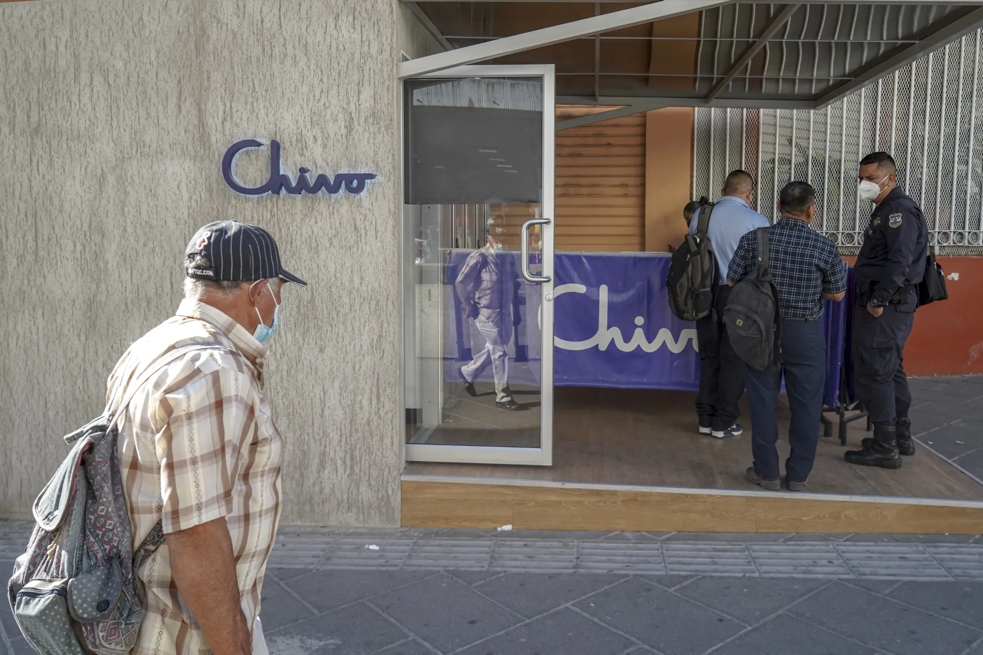 Customers wait to use a Chivo Bitcoin automated teller machine (ATM) in San Salvador.