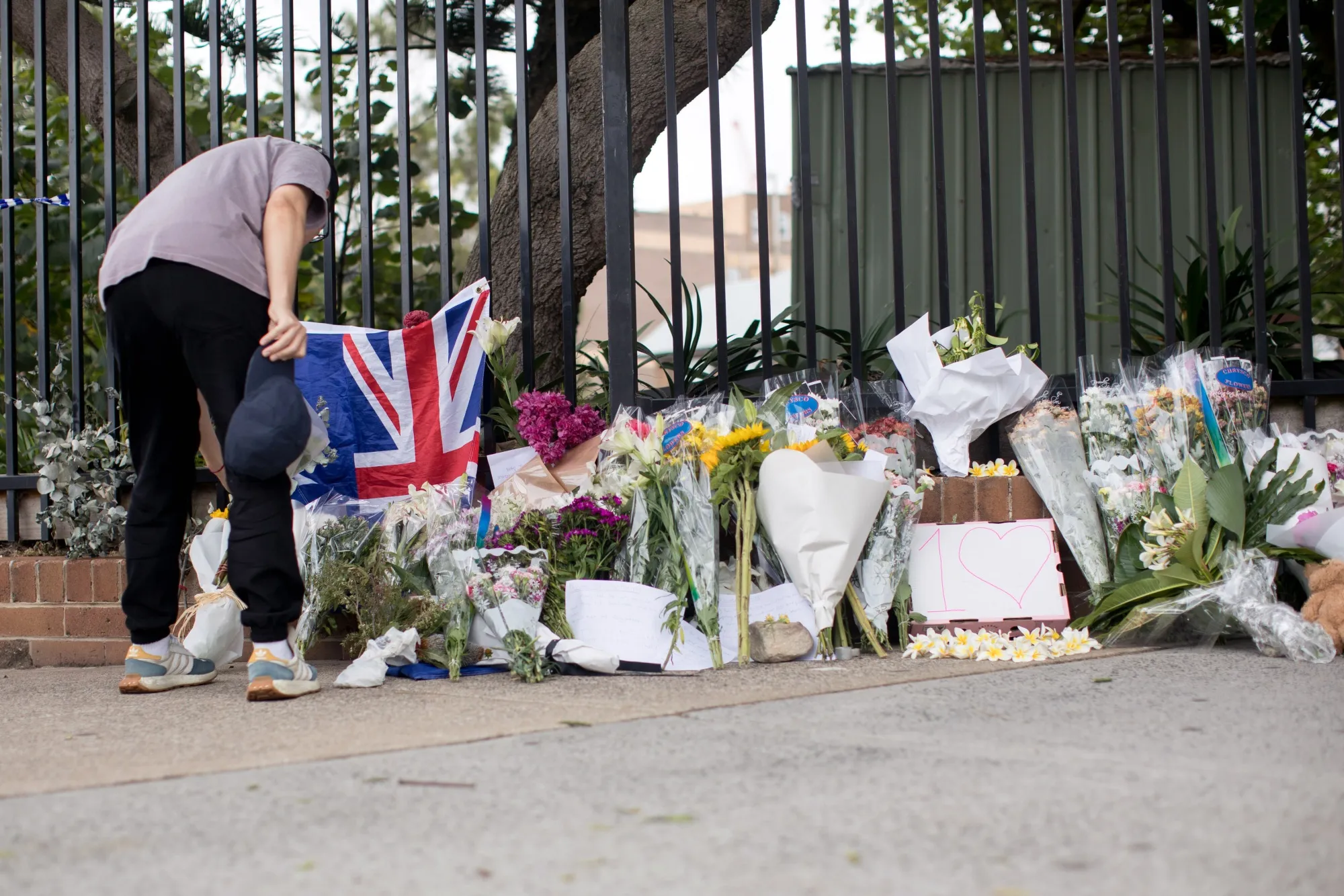 A mourner lays flowers near the scene of the mass shooting.
