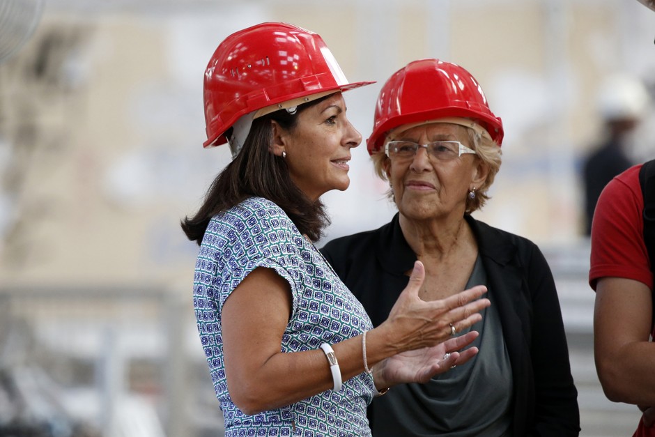 Paris' Mayor Anne Hidalgo, left, meets Madrid's Mayor Manuela Carmena at a French migrant centre in September 2016
