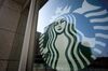 The Starbucks Corp. logo is displayed outside a store.