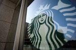The Starbucks Corp. logo is displayed outside a store.