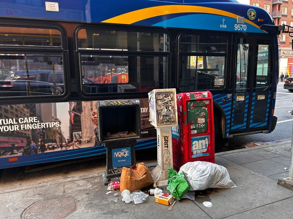 Garbage litters the street in front of a newspaper stand in Manhattan.&nbsp;