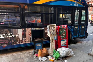 Garbage piled up in front of Newspaper stands at bus stop, Manhattan, New York