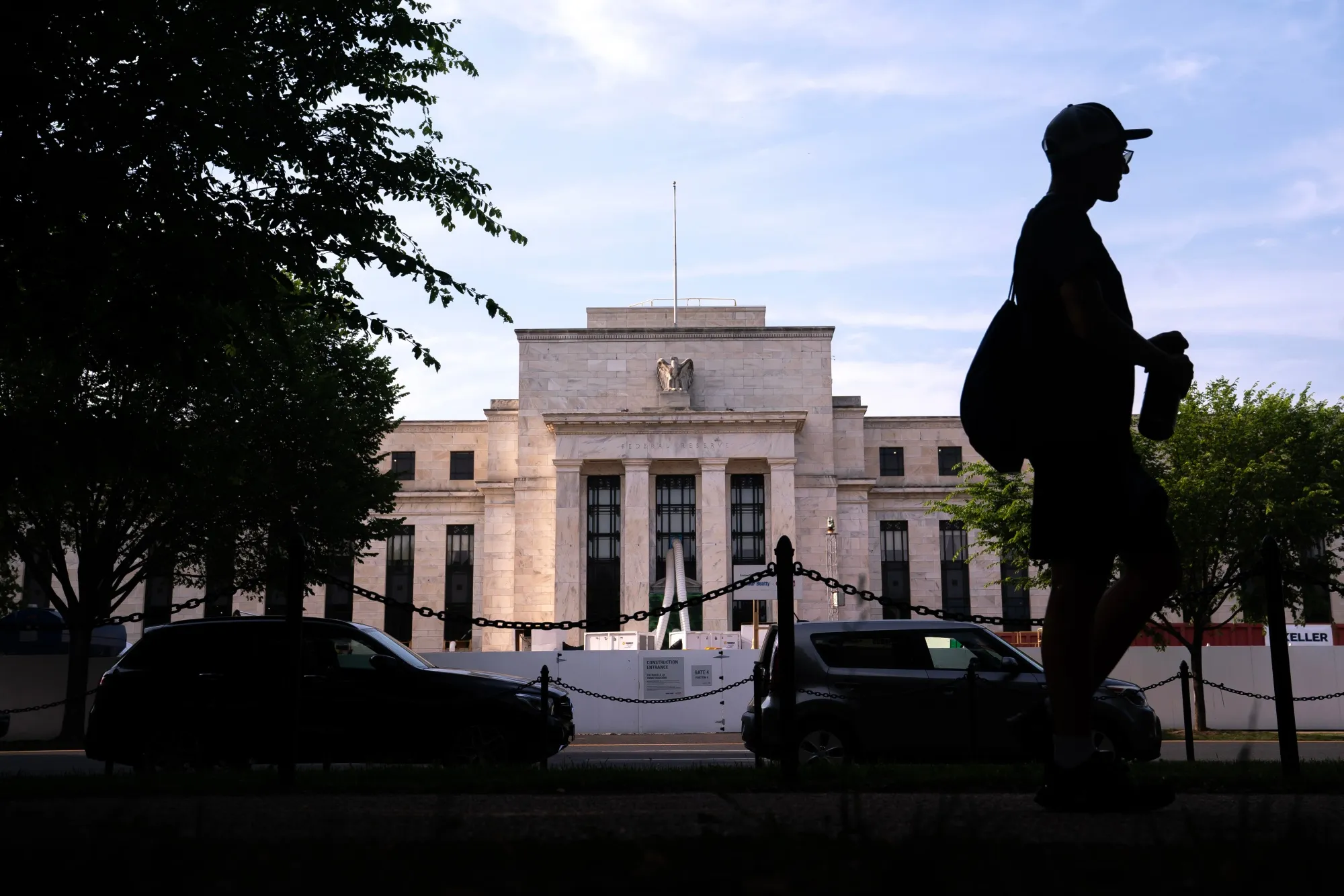 A pedestrian passes the Federal Reserve building in Washington, DC.