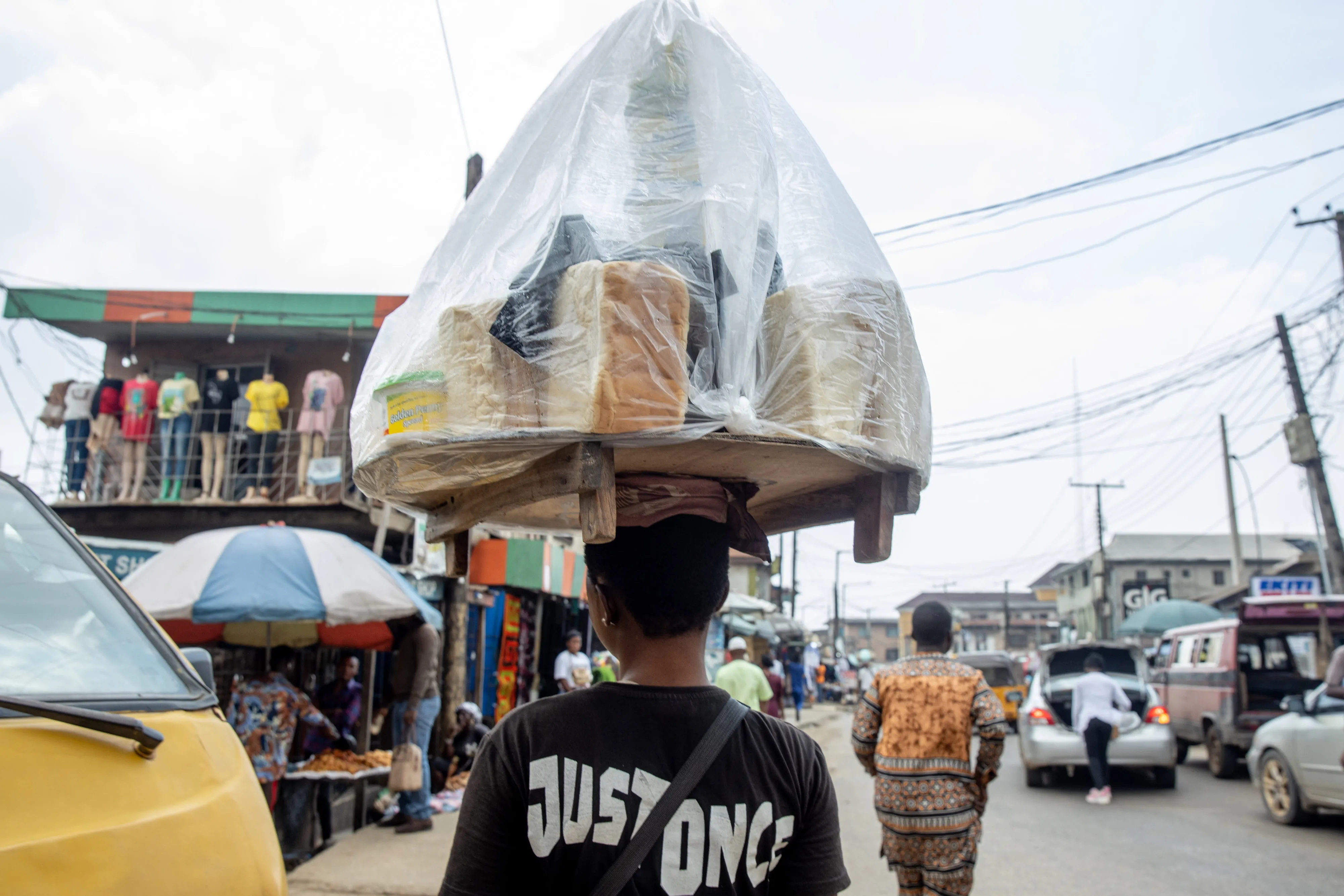 A&nbsp;street vendor carries bread and food items in Lagos.&nbsp;