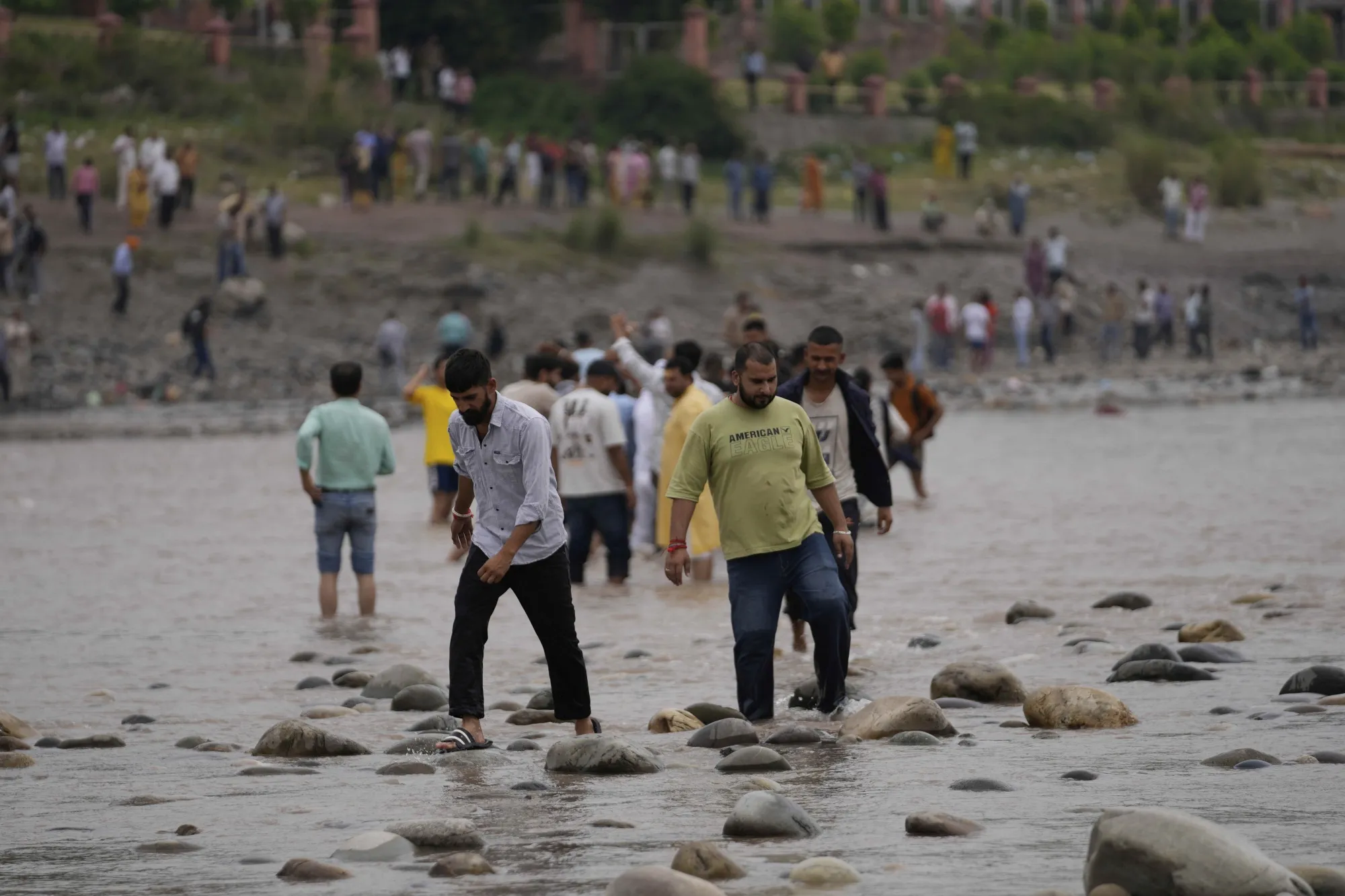 People cross the Chenab River at Akhnoor, India, on May 5.
