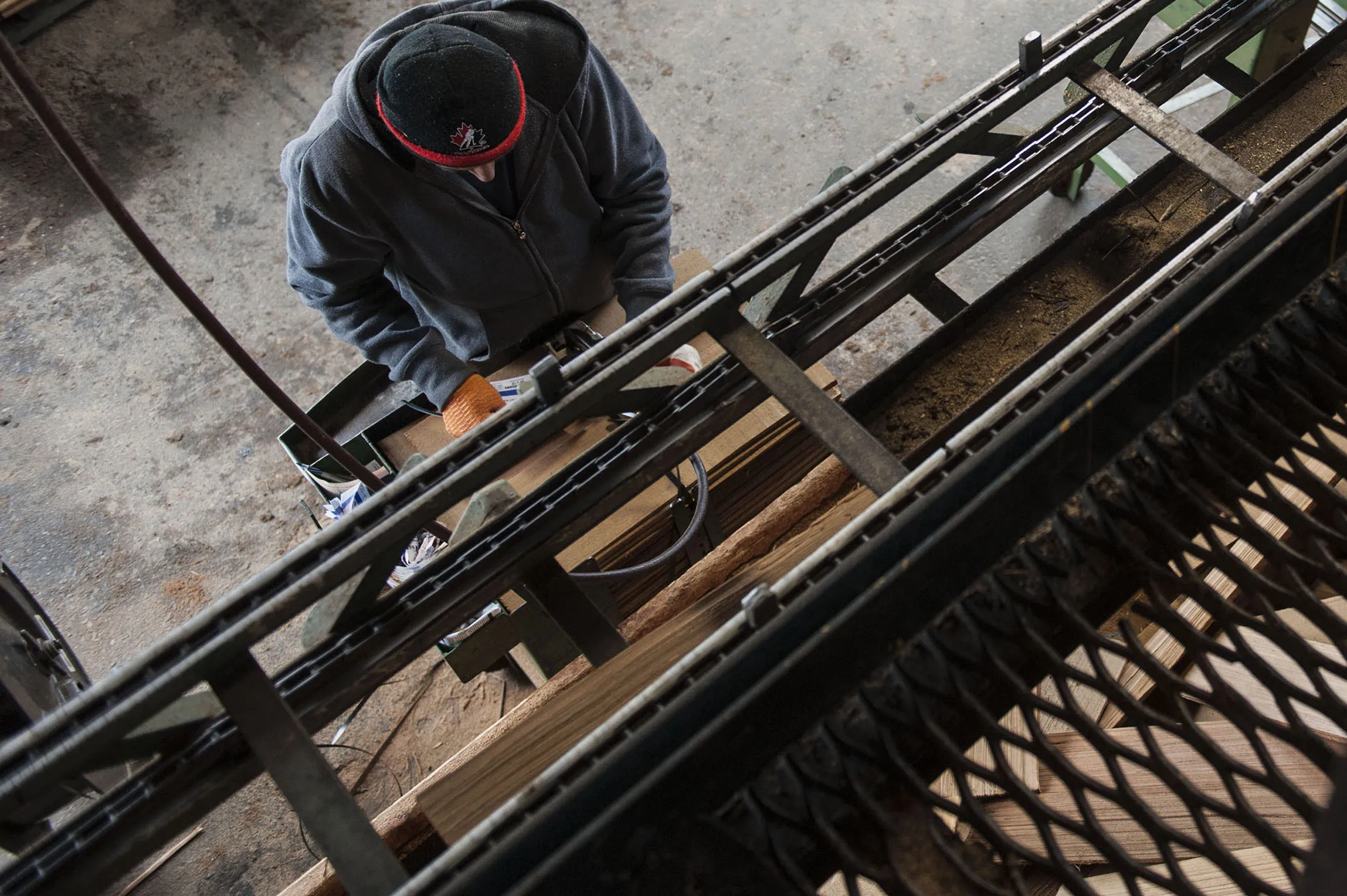 A worker sorts cedar logs to manufacture shakes and singles in Maple Ridge, British Columbia, Canada.
