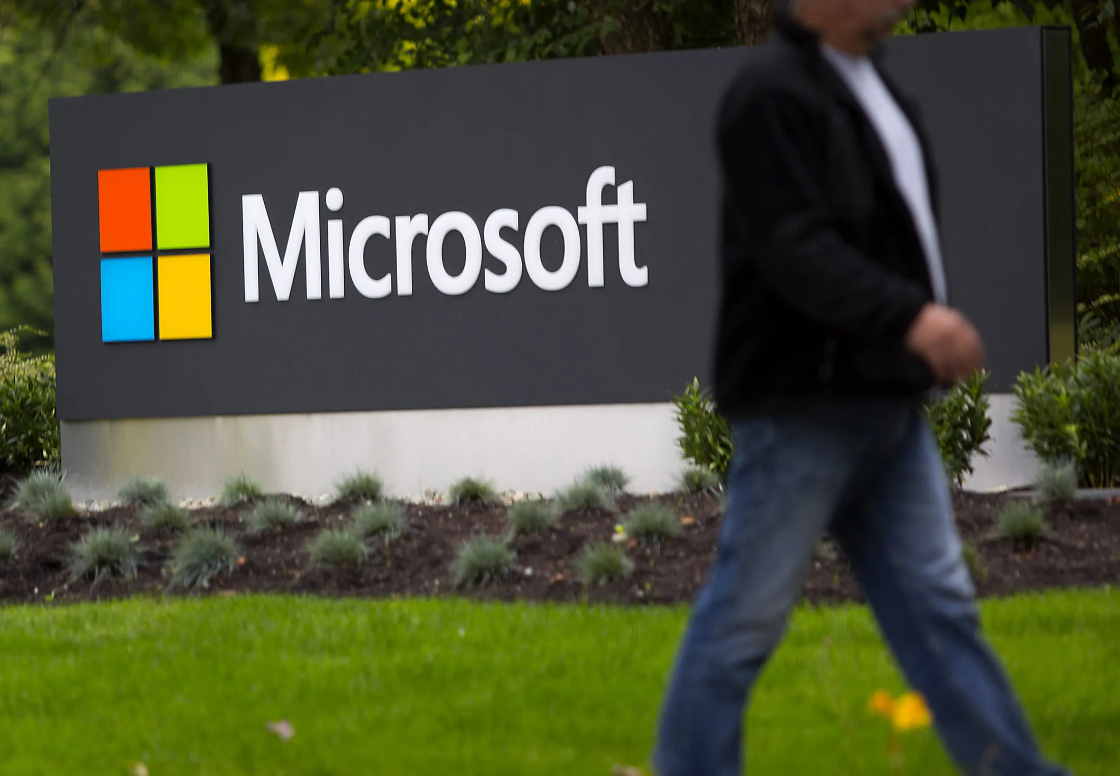 A pedestrian walks by at the Microsoft campus in Redmond, Washington.