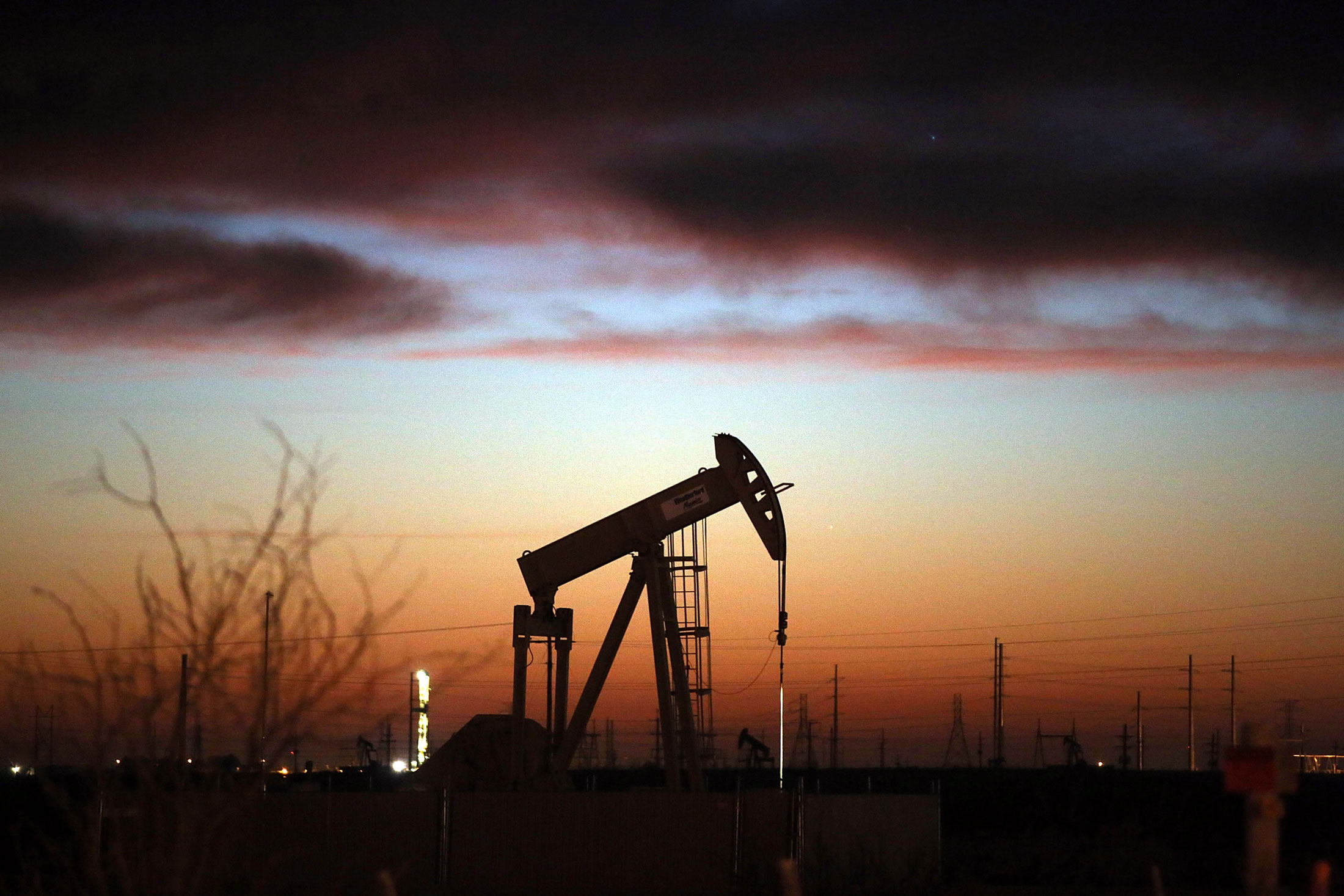 An oil pumpjack seen at dawn in the Permian Basin oil field in Andrews, Texas.
