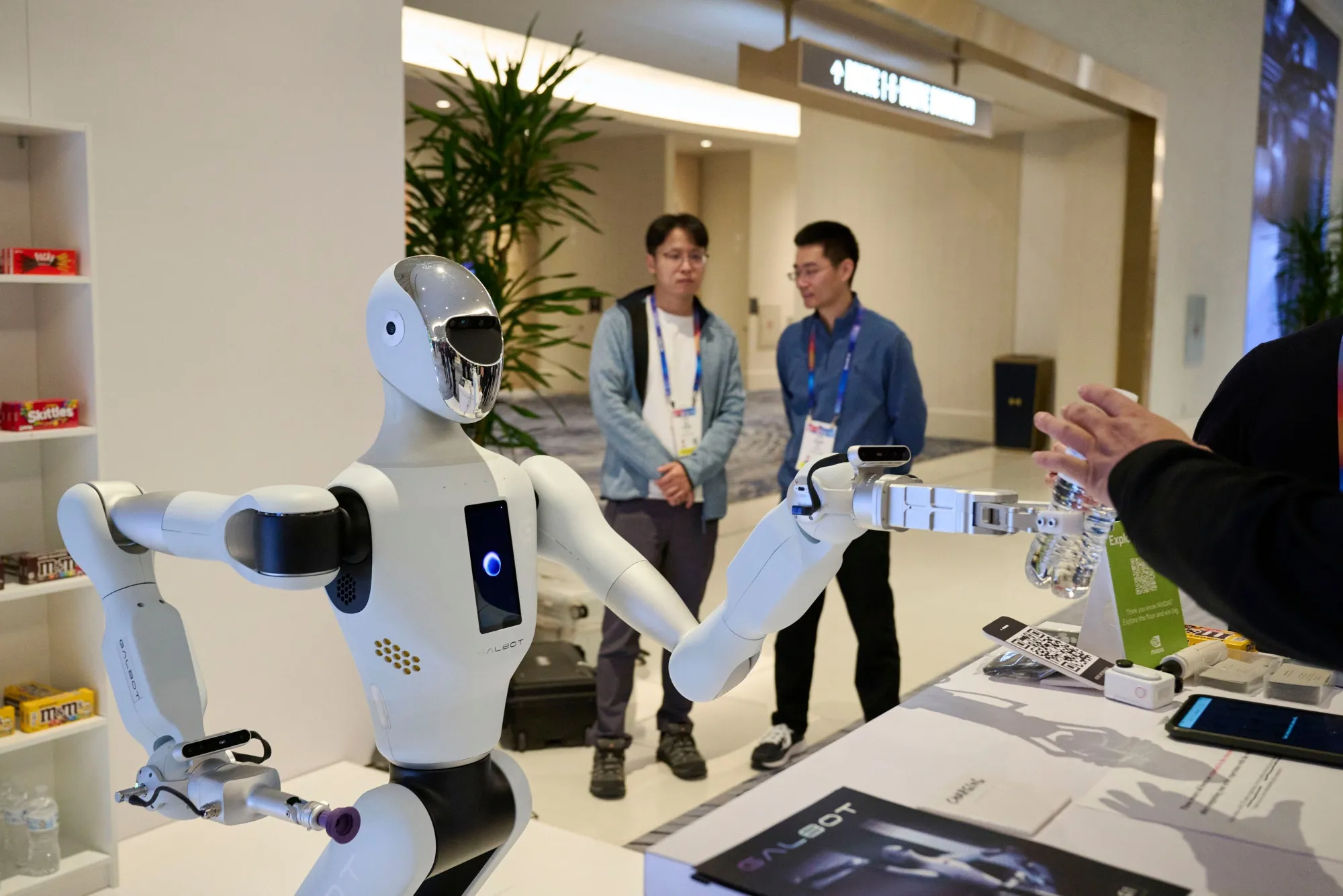 The Nvidia Galbot gives a water bottle to an attendee during the 2025 CES event in Las Vegas.