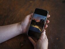 Casey Douglas shows phone photos from the black summer at her property in Nelligen, Thursday 25th January, 2023.
