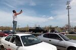 A man in Puerto Rico tries to get cell phone service from a mobile phone antenna. 