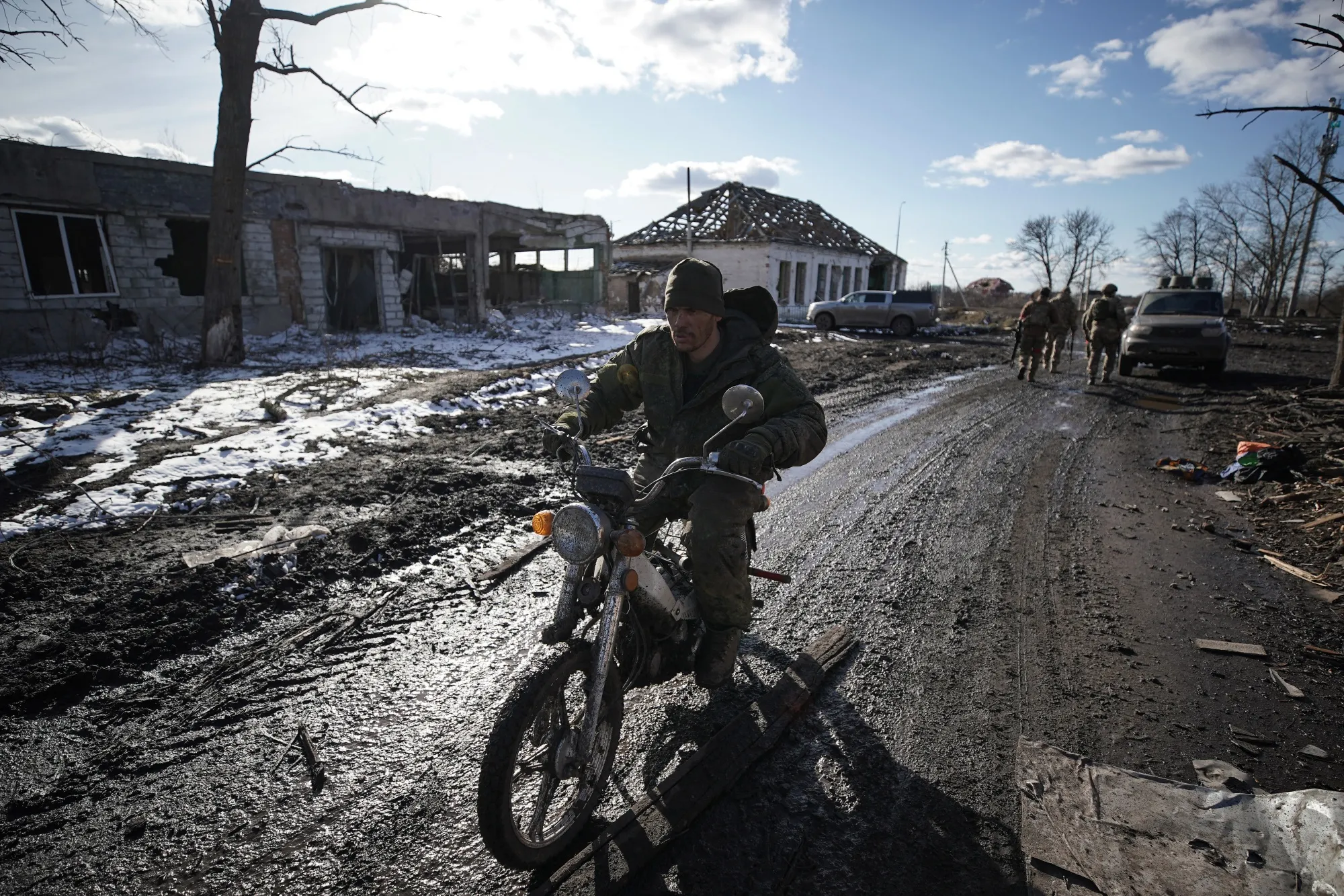 A Russian soldier rides a motorbike past destroyed buildings in the village of Kazachya Loknya in the Kursk region on March 18.