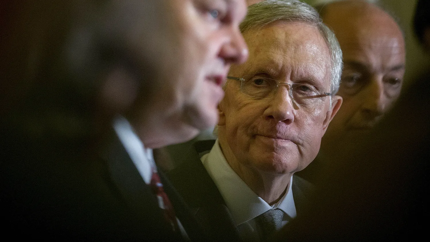 Senate Majority Leader Harry Reid, a Democrat from Nevada, right, looks on as Senator Jon Tester, a Democrat from Montana, speaks during a news conference following a private meeting at the U.S. Capitol Building in Washington, D.C., U.S., on Thursday, Nov. 13, 2014.
