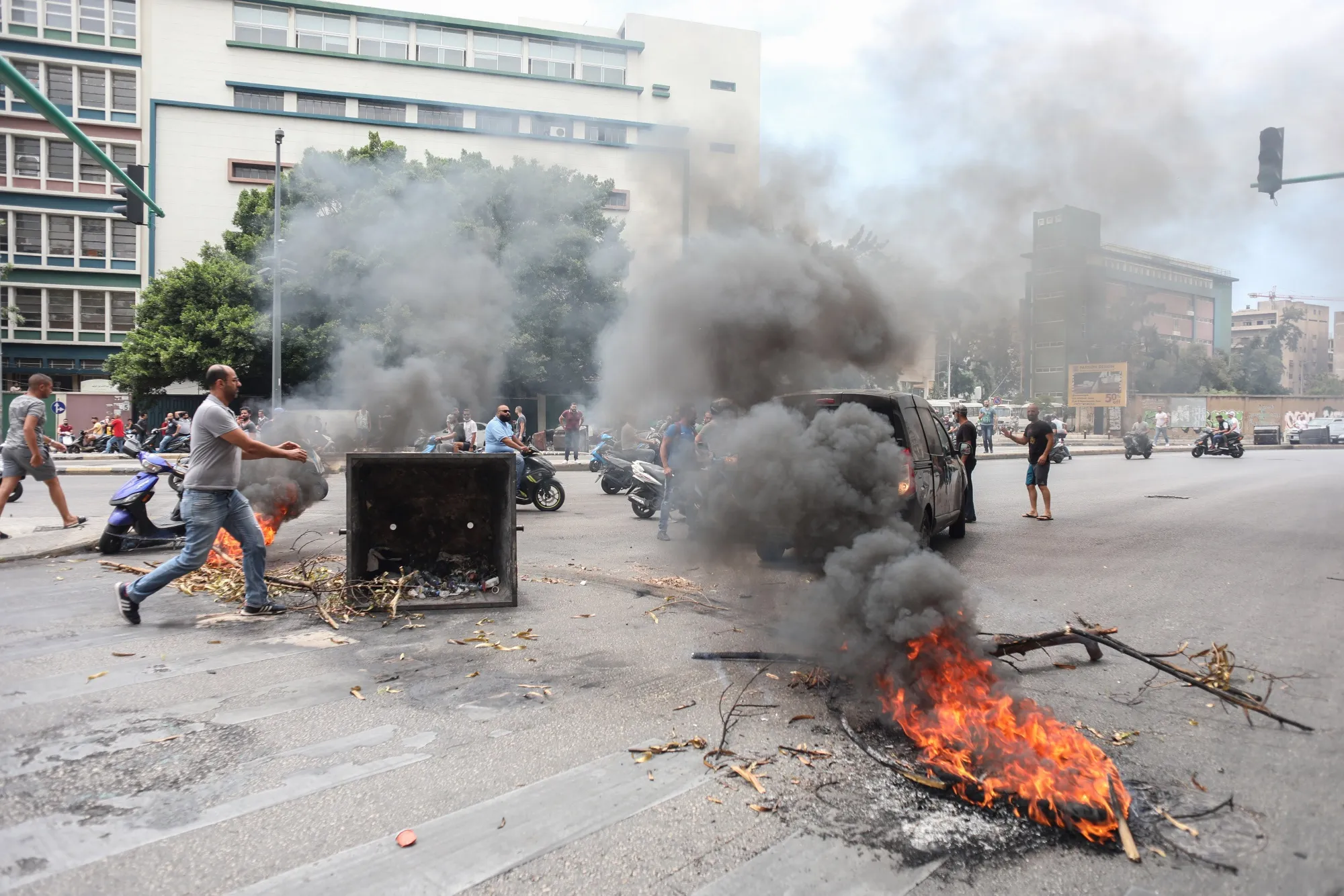 Demonstrators light fires at a road block during an anti-government protest in Beirut, Lebanon, on July 1.