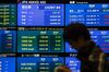 A man walks past a screen displaying share prices inside the Tokyo Stock Exchange (TSE), operated by Japan Exchange Group Inc. (JPX), in Tokyo, Japan, on Friday, April 26, 2019. Japan's retail investors have propelled their net long yen positions against the dollar to near a record ahead of the nation's extended Golden Week holidays.