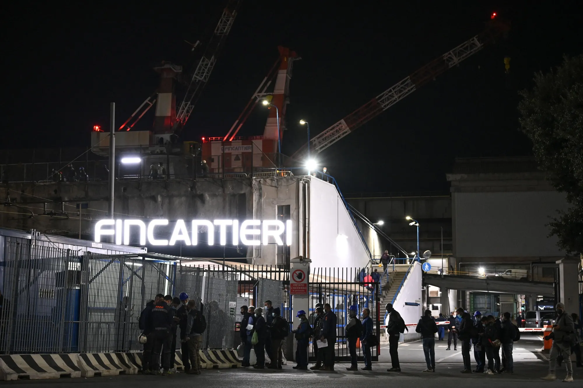Workers&nbsp;at the entrance of the Fincantieri shipyard in the port of Genoa, Liguria.