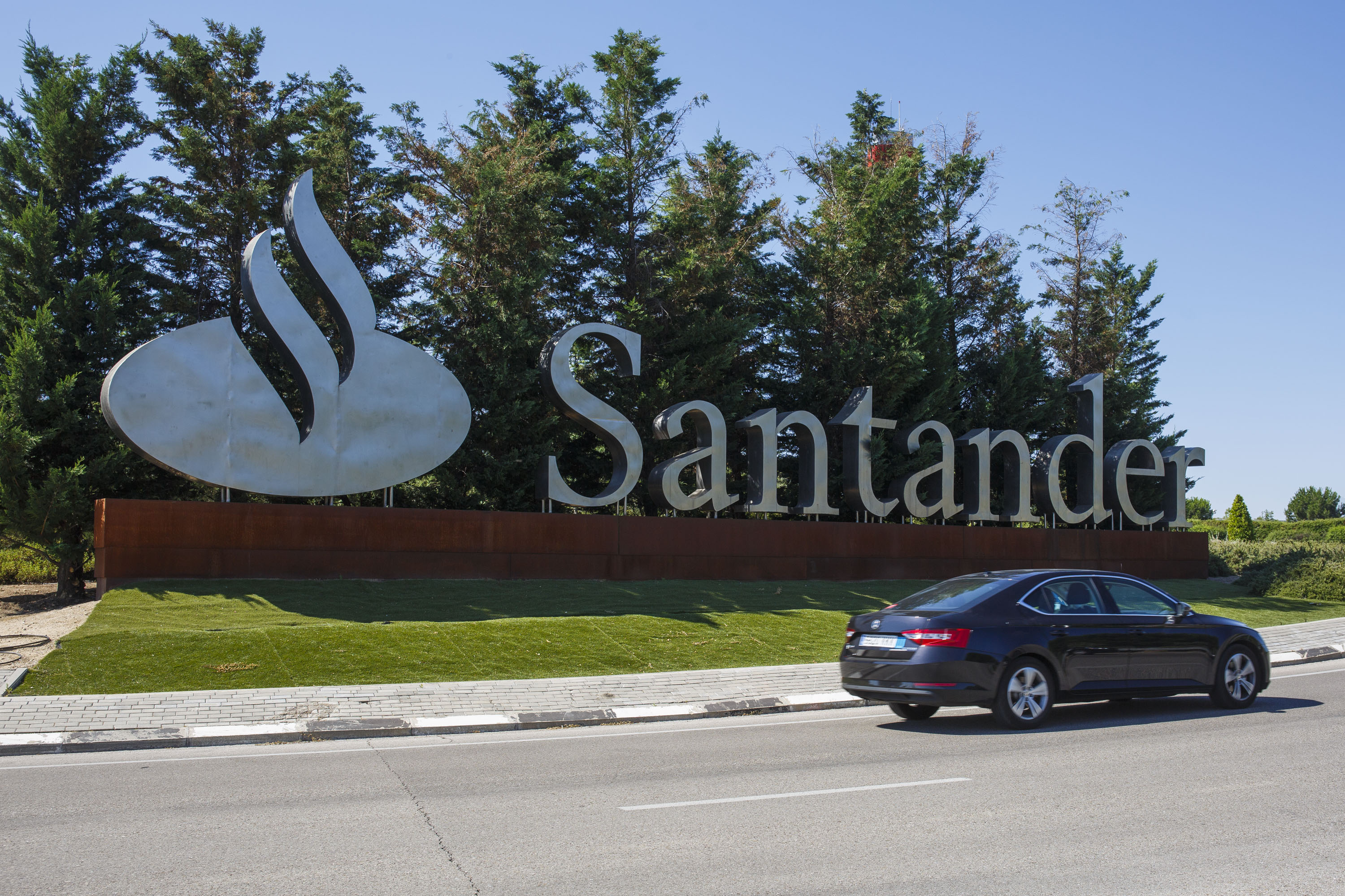 A sign sits on a roundabout outside the headquarters of Banco Santander SA in Boadilla del Monte, Spain.