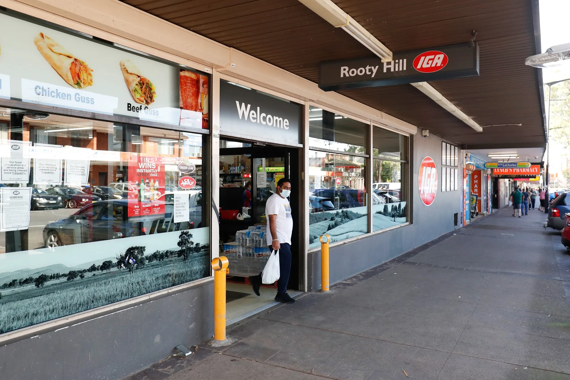 A shopper wearing a protective mask exits a supermarket during a partial lockdown in Sydney,.