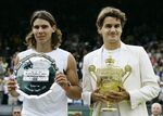 Defending champion Roger Federer, right, holds the winners trophy with runner up Rafael Nadal of Spain after the Men's Singles final on the Centre Court at Wimbledon, Sunday July 9, 2006. Federer won the match 6-0, 7-6, 6-7, 6-3. Federer announced Thursday, Sept.15, 2022 he is retiring from tennis. (AP Photo/Anja Niedringhaus, File)