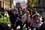 Jacob Rees-Mogg surrounded by police, walks through protestors in Victoria square as he arrives on the first day of the Conservative Party Conference at the ICC in Birmingham, England, on Oct.&nbsp;2.