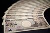 Japanese ten-thousand yen banknotes are arranged for a photograph in Kawasaki, Kanagawa Prefecture, Japan, on Monday, Dec. 10, 2012. The yen is losing its status as a haven for risk-averse investors as Japan lurches toward a chronic trade deficit and the front-runner to become the next prime minister calls for unlimited central-bank stimulus.