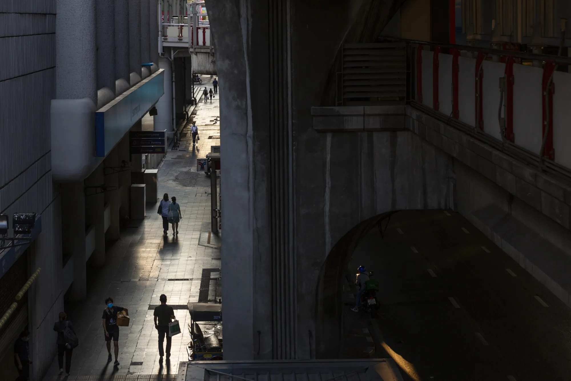 People walk near Siam Square in Bangkok on April 3.