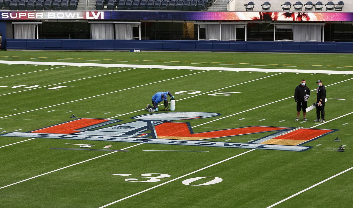 01 February 2022, US, Inglewood: Workers paint the Super Bowl LVI