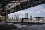 A pedestrian walks on a riverside path near the Lujiazui financial district in Shanghai.