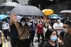 Demonstrators raise their hands to gesture the "Five demands, not one less" protest motto in the Central district during a protest in Hong Kong, China, on Wednesday, May 27, 2020.