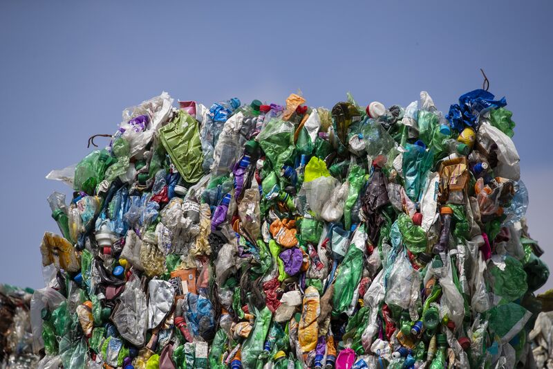 Crushed plastic bottles and containers sit bound in a bale ready to be recycled at a waste recycling center in Duiven, Netherlands.