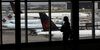 A traveler walks past Air Canada planes at Toronto Pearson International Airport (YYZ) in Toronto.