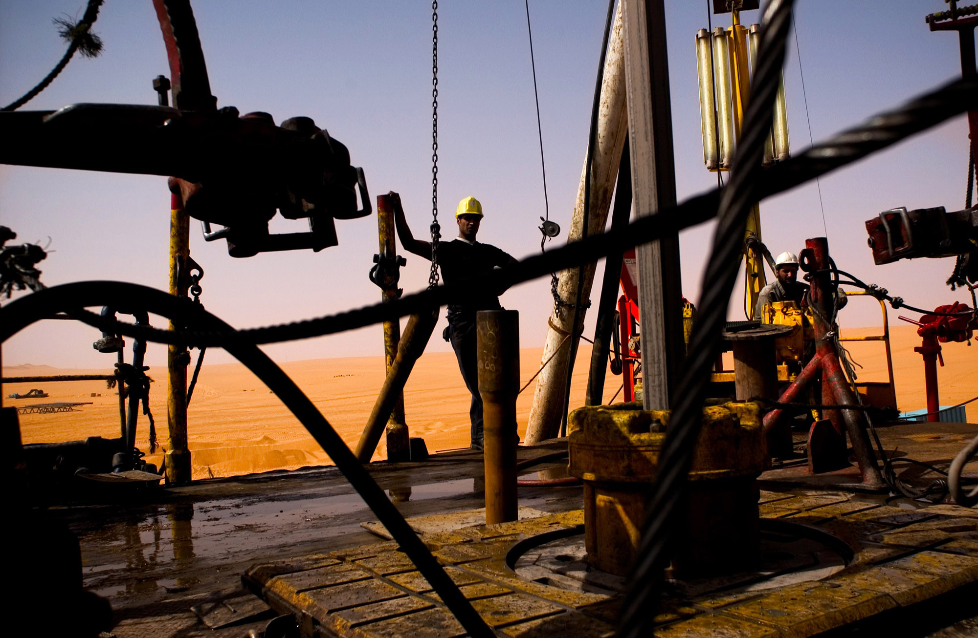 A worker stands on an oil drilling rig in El-Sharara, Libya.