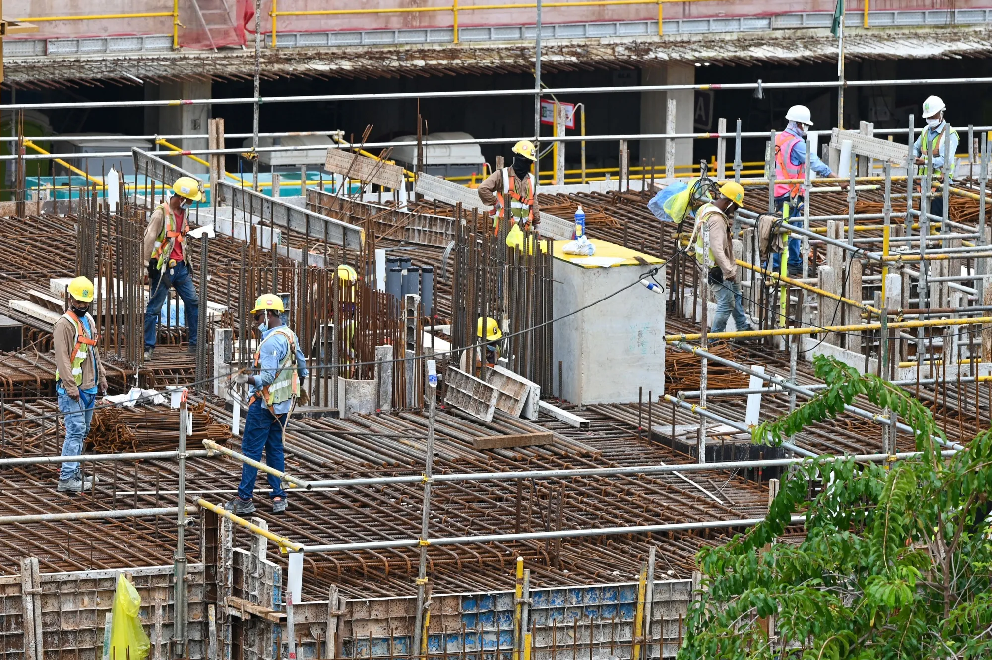 Migrant workers work at at a construction site in Singapore.