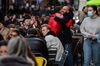 People drinking outside as non essential retail reopens, in London on April 12. 