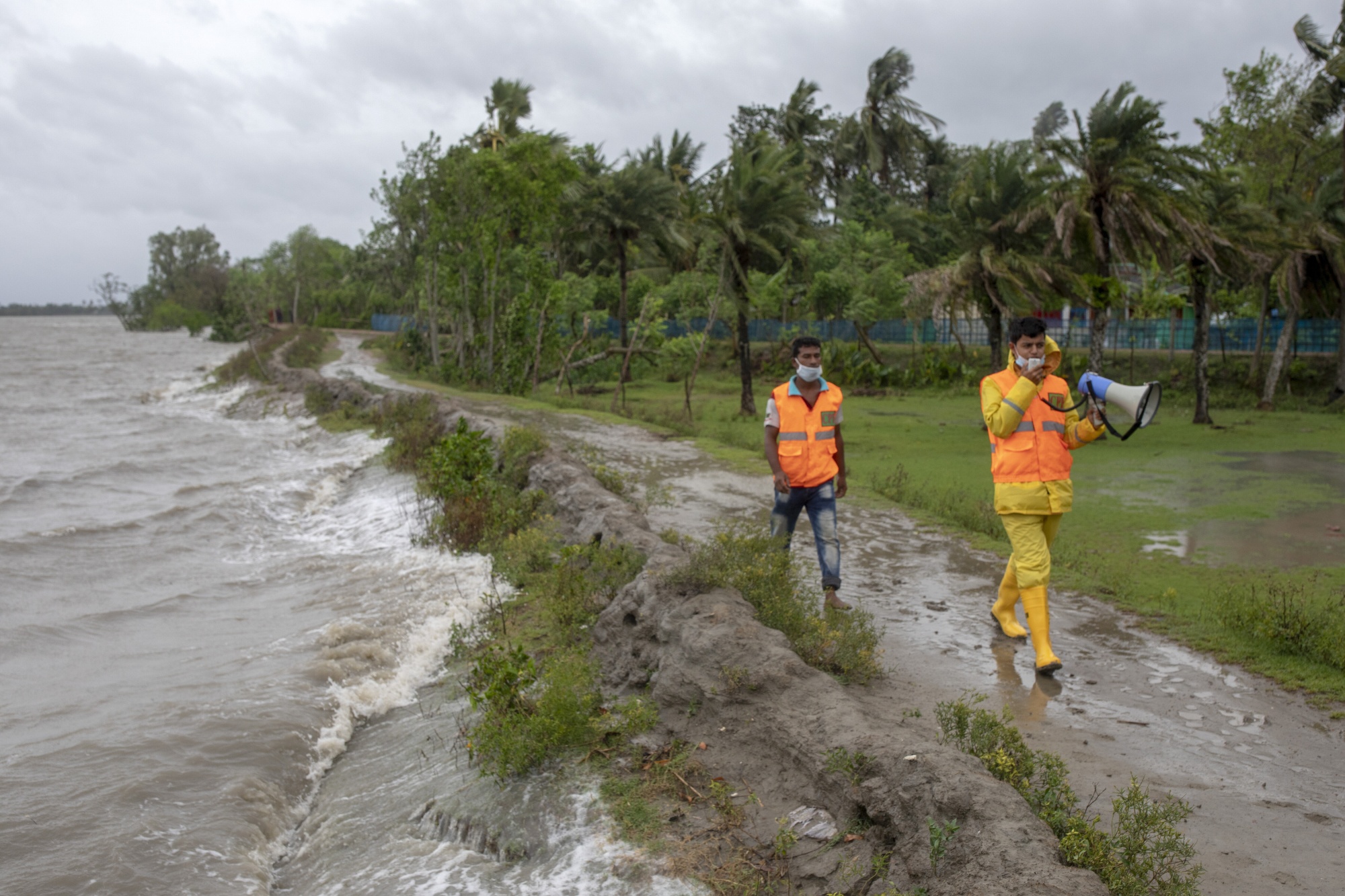 Volunteers urge residents to evacuate to shelters ahead of cyclone Amphan in Dakop, Bangladesh, May 20.