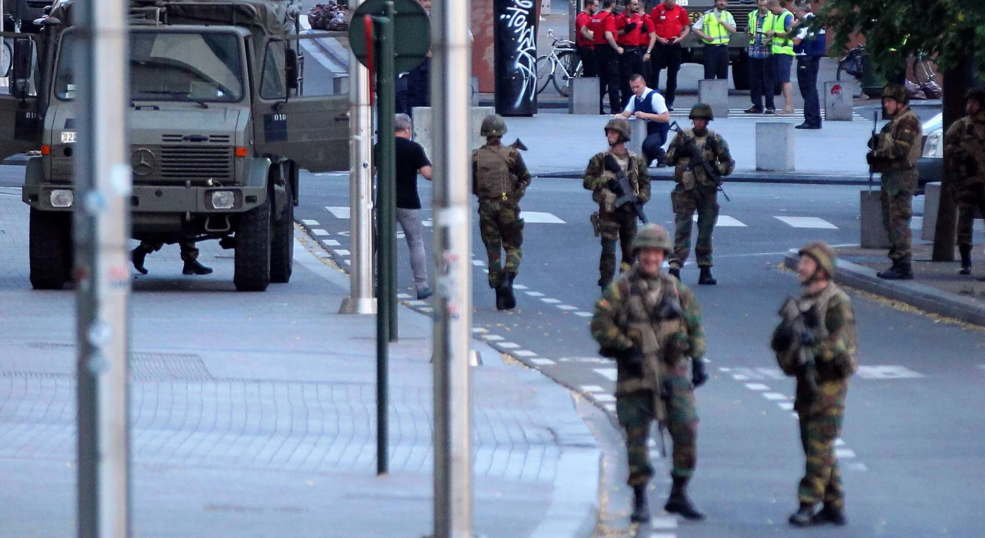 Armed soldiers and police officers stand guard outside of the Brussels Central Station on June 20, 2017.
