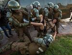 A demonstrator is arrested by riot police during a protest for the death of Mapuche Camilo Catrillanca in Santiago, on Nov. 15. 