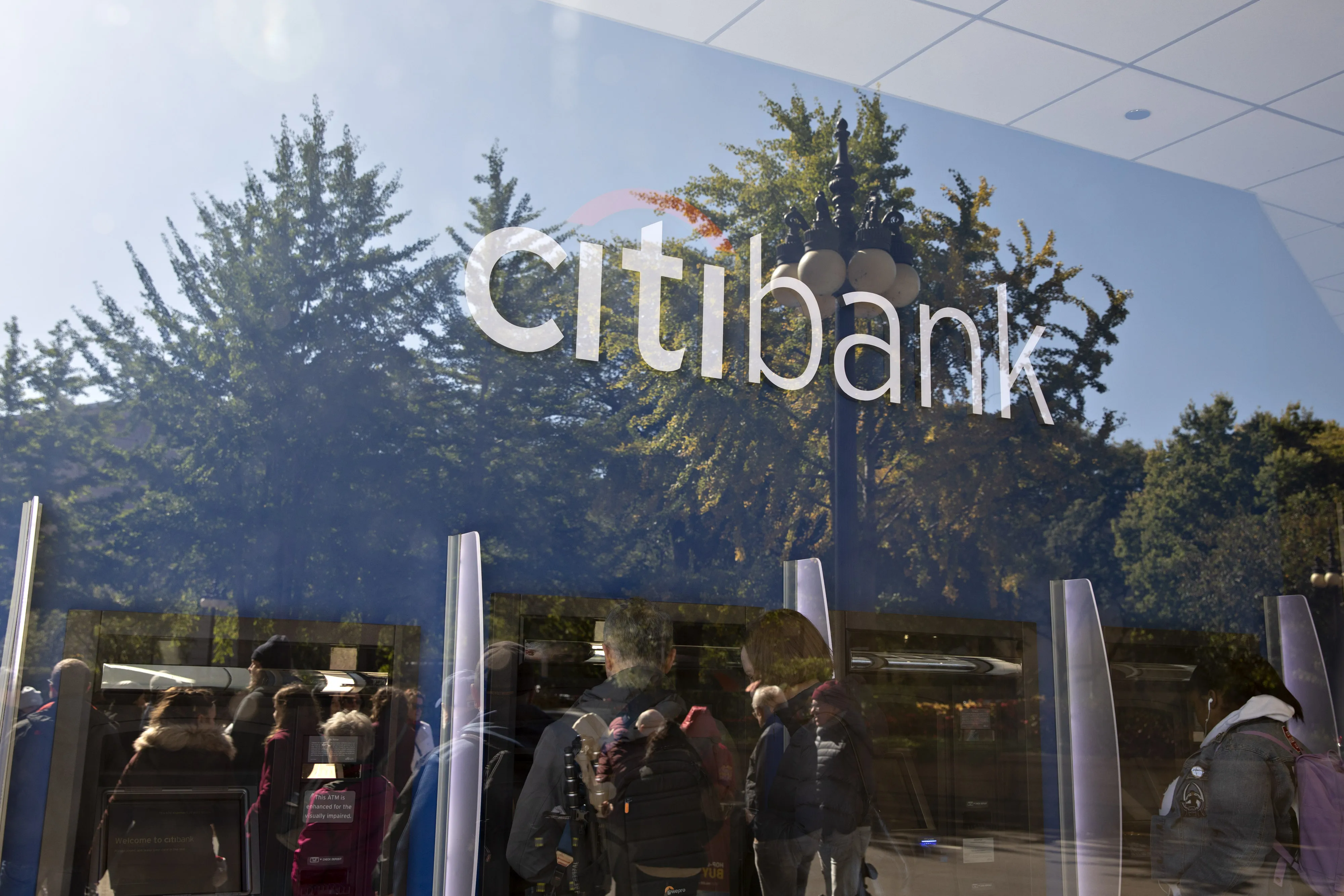 Customers use an ATM at a Citibank branch.