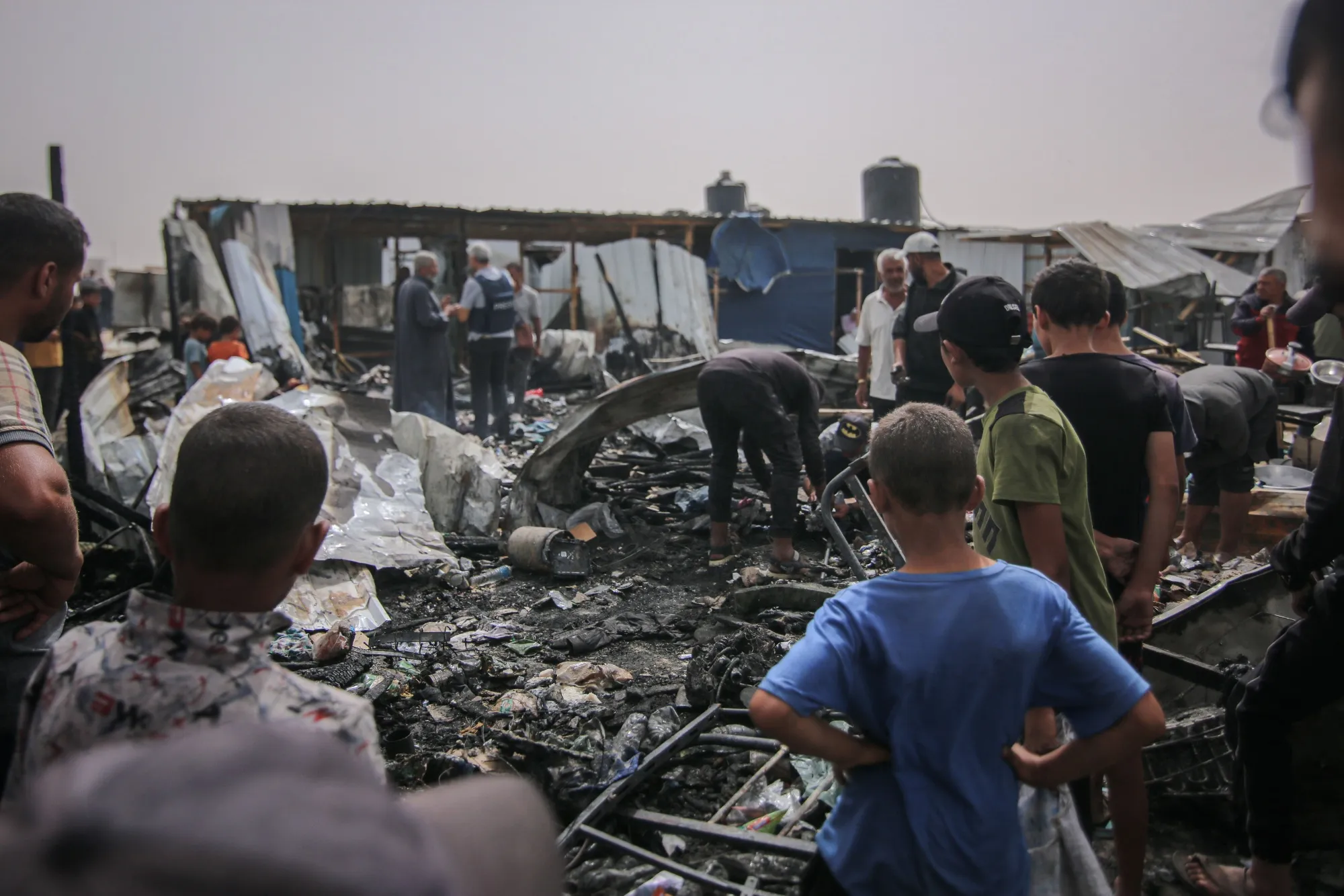 Palestinians at the site of an Israeli strike on an area designated for displaced people in Rafah, southern Gaza Strip, on Monday, May 27, 2024.