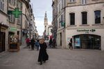 Pedestrian pass a Carrefour City supermarket in Avignon, France.