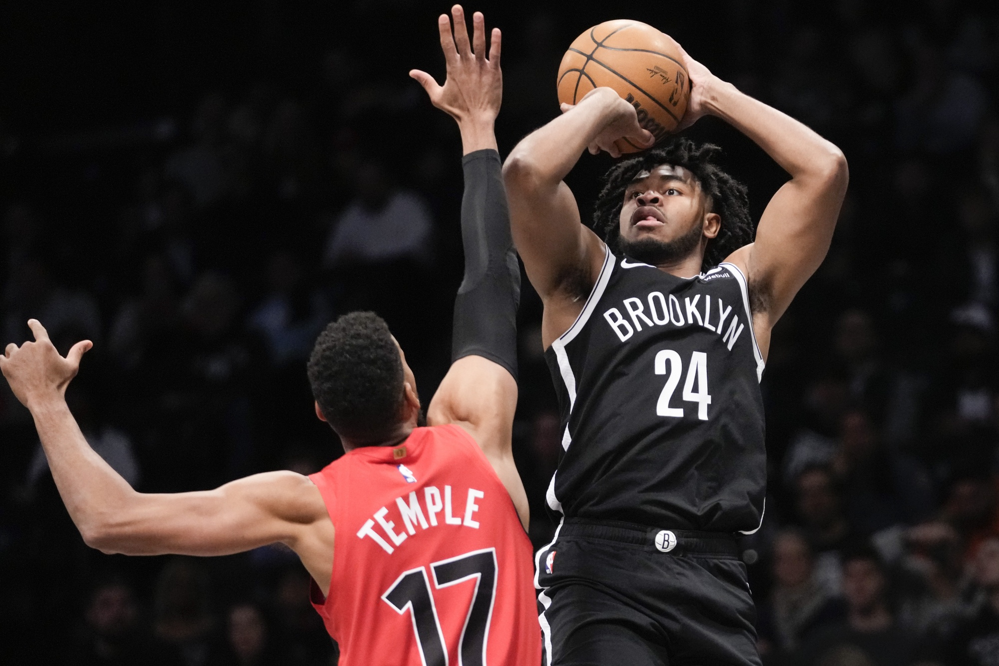Brooklyn Nets guard Cam Thomas (24) shoots against Toronto Raptors forward Garrett Temple (17) during the first half of an NBA basketball game Wednesday, April 10, 2024, in New York. (AP Photo/Mary Altaffer)