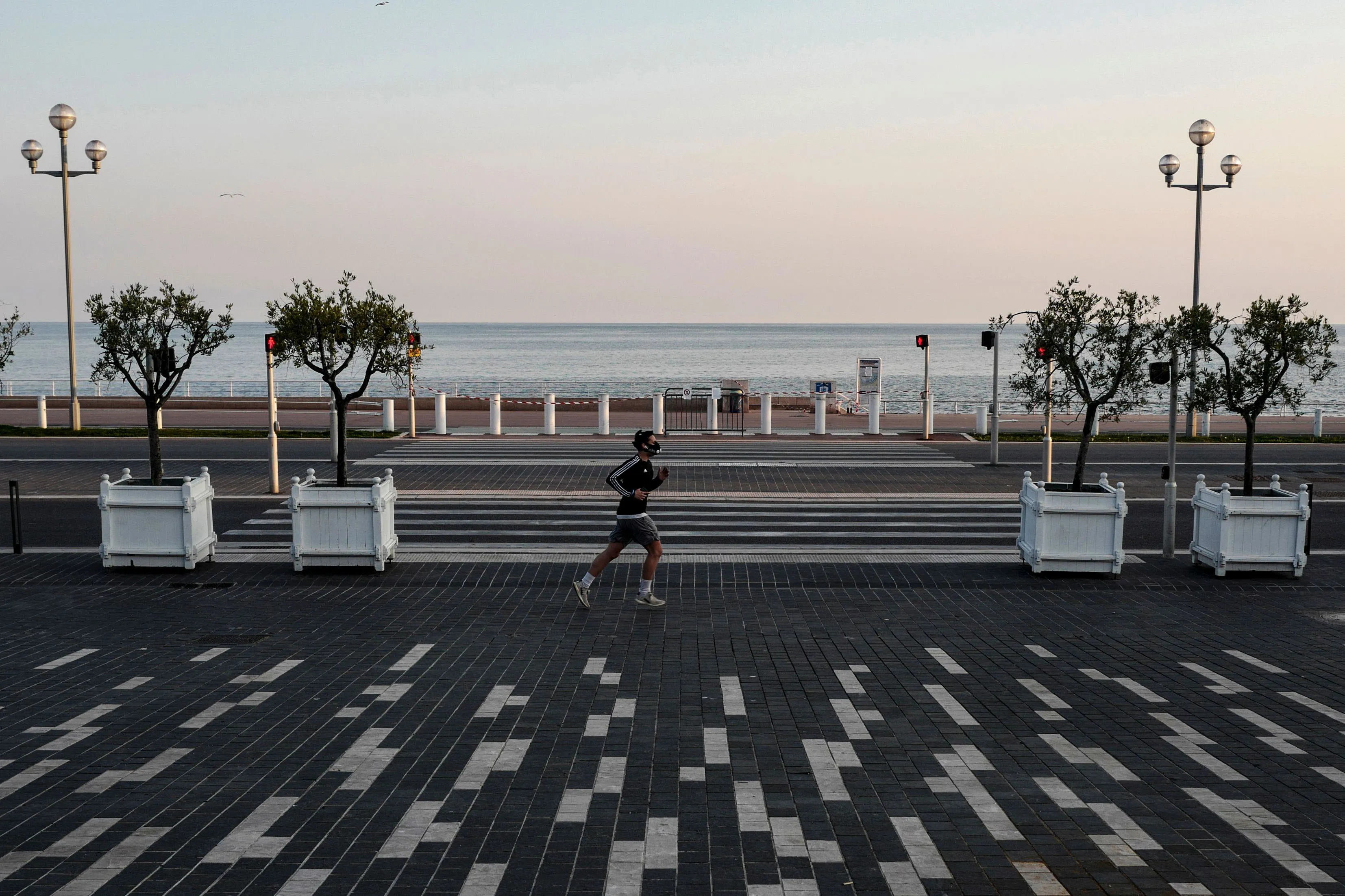 A man runs along the 'Promenade des Anglais' during national lockdown on the French Riviera in Nice, southern France.