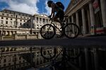 A cyclist passes the Bank of England&nbsp;in the City of London.