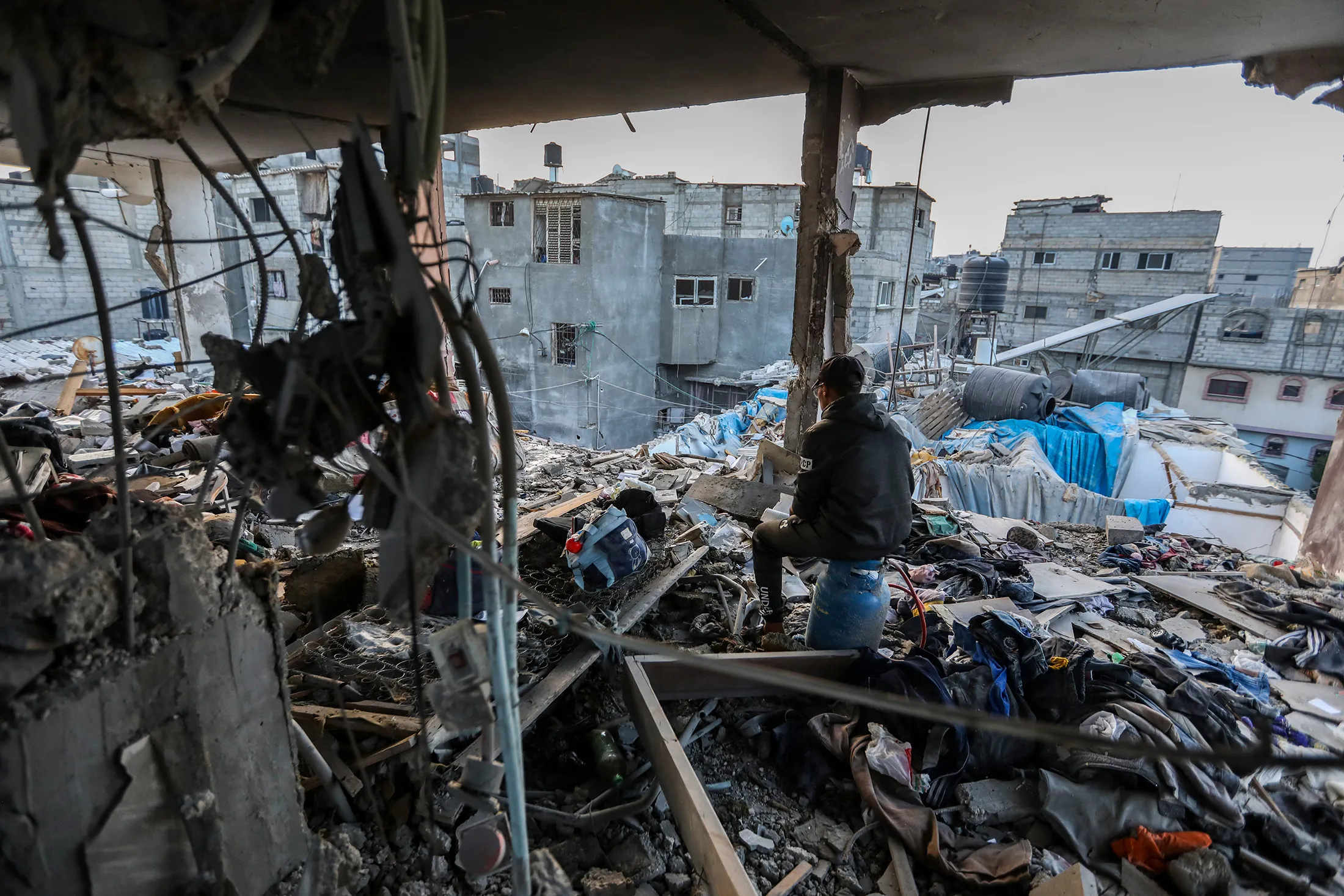 A Palestinian resident inspects the destruction of their home following an airstrike in Khan Younis, southern Gaza, on Dec. 3.