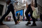 Pedestrians pass in front of the New York Stock Exchange (NYSE) in New York.