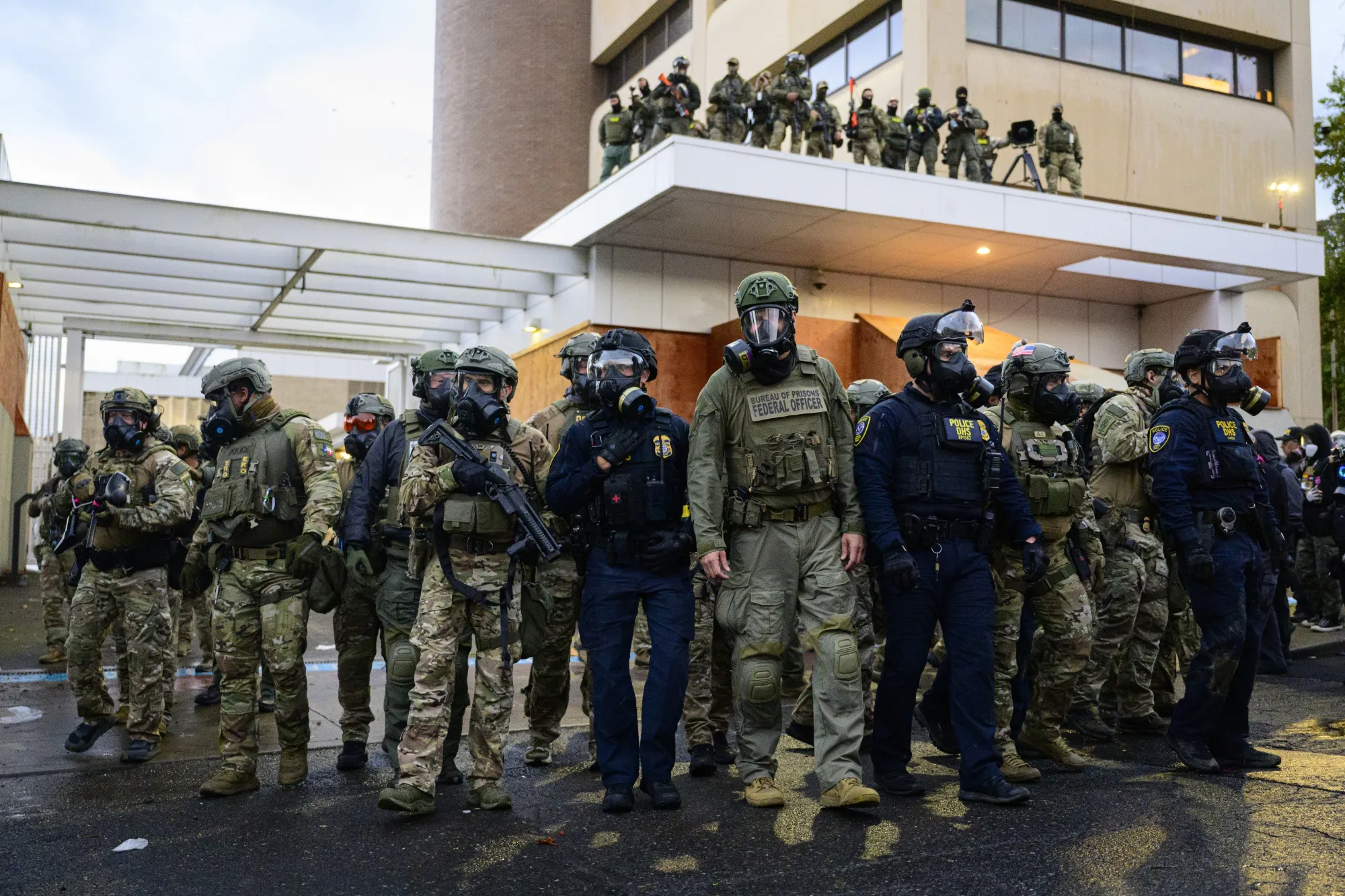 Federal agents at the US Immigration and Customs Enforcement building in Portland, Oregon, on Oct. 12.